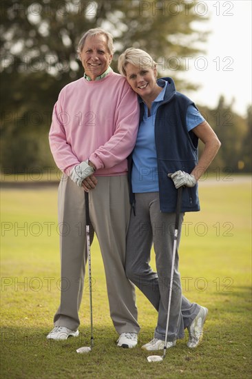 Couple standing on golf course