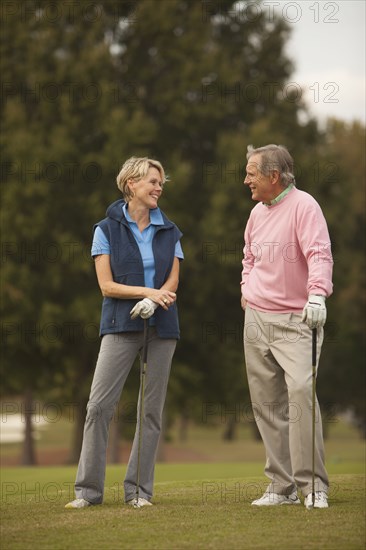 Couple standing on golf course