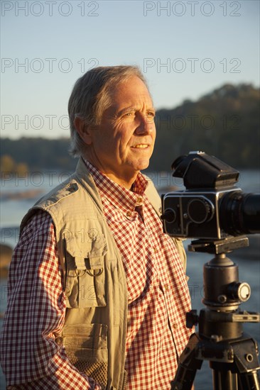 Man taking photographs on beach