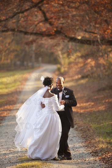 Bride and groom standing on path