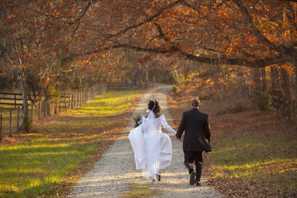 Bride and groom walking on path