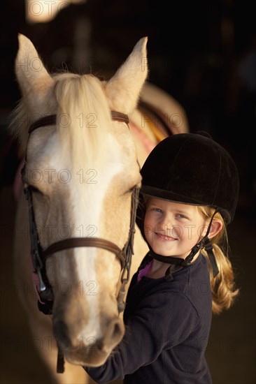 Caucasian girl standing with horse