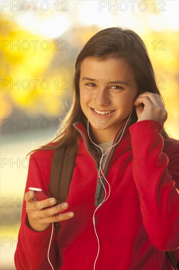 Caucasian girl listening to mp3 player