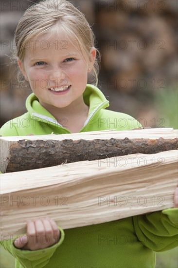 Caucasian girl carrying firewood