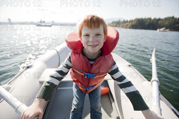 Caucasian boy rowing on boat