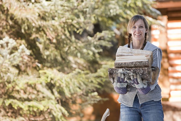 Caucasian woman carrying firewood