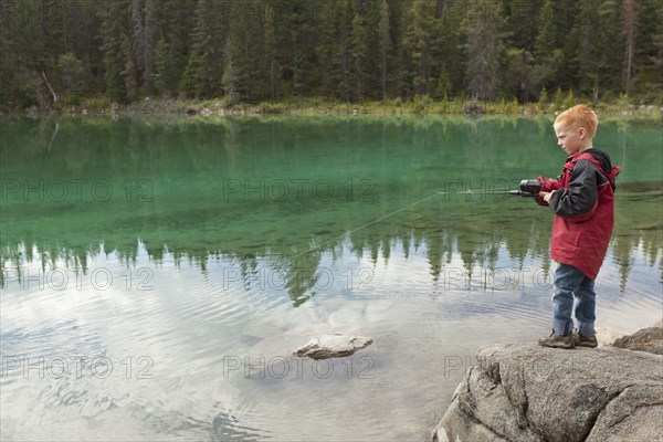 Caucasian boy fishing in the Valley of the Five Lakes