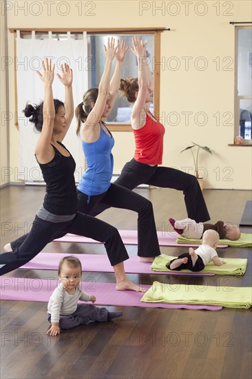 Mothers and babies taking yoga class