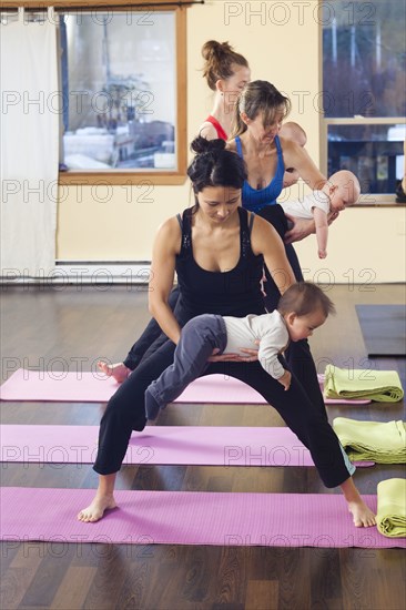 Mothers and babies taking yoga class