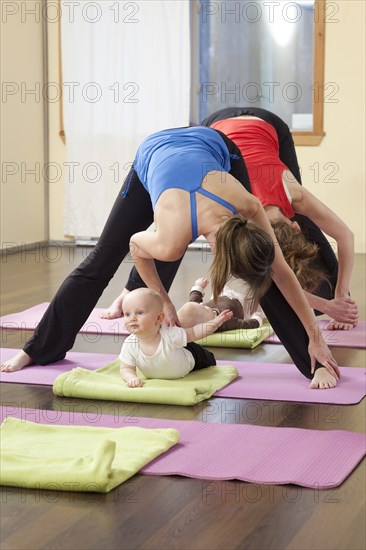 Mothers and babies taking yoga class