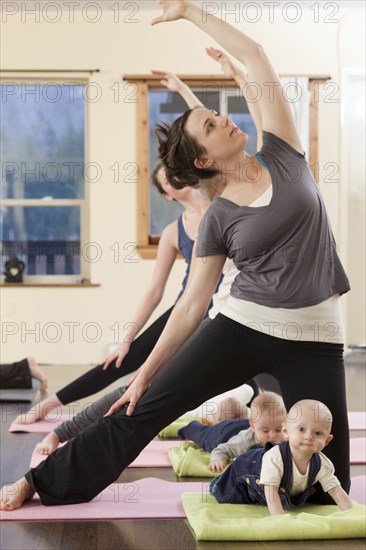 Mothers and babies taking yoga class