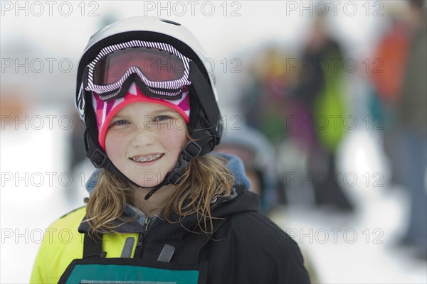 Caucasian girl wearing ski gear in snow