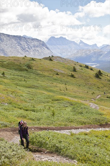 Caucasian mother and baby on path in mountain landscape