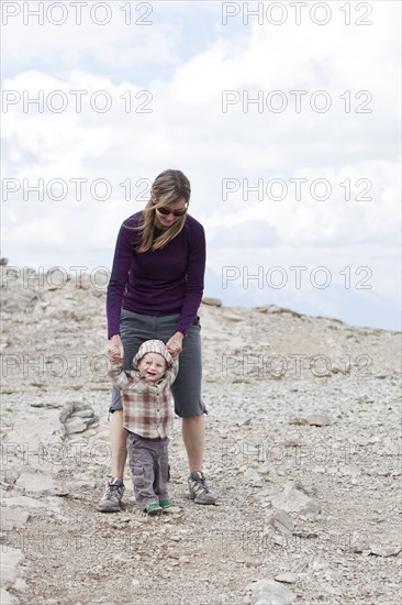 Caucasian mother and baby in rocky landscape