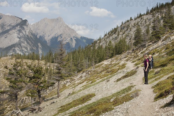 Caucasian mother and son hiking on remote hillside