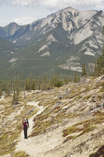 Caucasian mother and son hiking on remote hillside