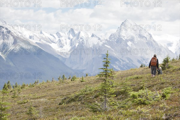 Caucasian mother and son hiking on remote hillside