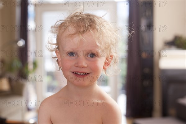 Caucasian boy smiling in living room