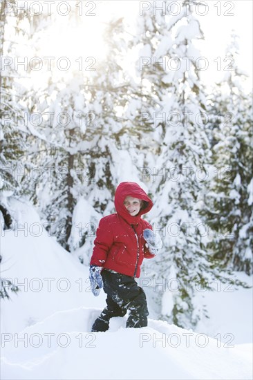 Caucasian boy snowshoeing on hillside