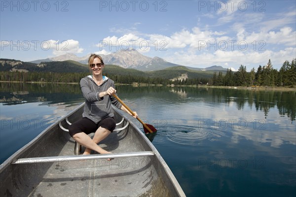 Caucasian woman paddling in kayak
