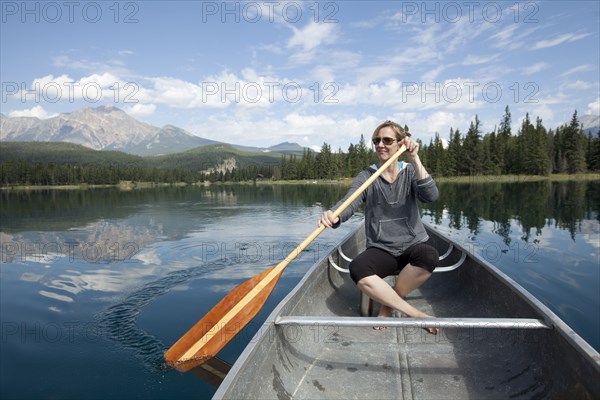 Caucasian woman paddling in kayak