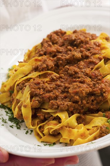 Close up of meat ragu over noodles