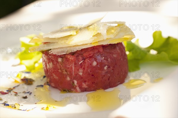 Parmesan cheese atop steak tartare