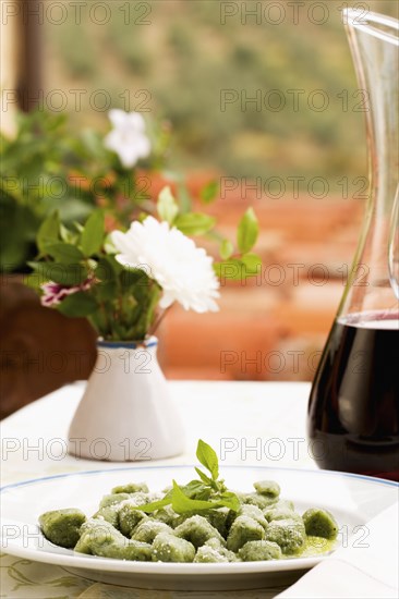 Spinach gnocchi and carafe of red wine