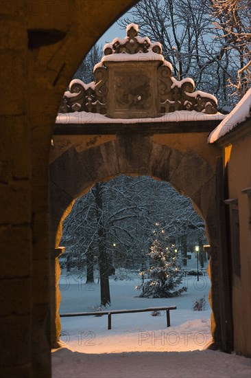 Arch and park in snow covered village