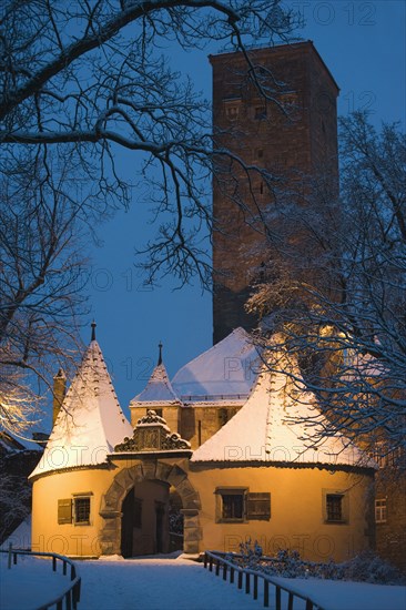 Snow covered village building at night