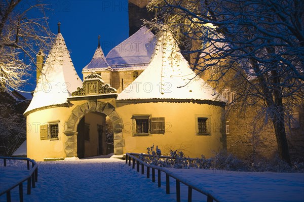 Snow covered village building at night