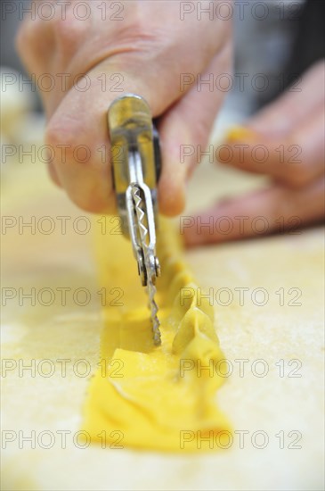 Chef cutting homemade agnolotti pasta