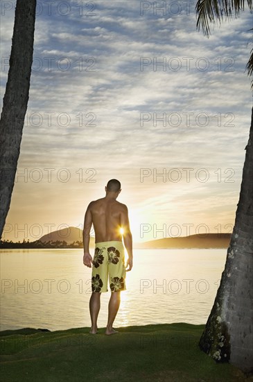 Asian man watching sunset