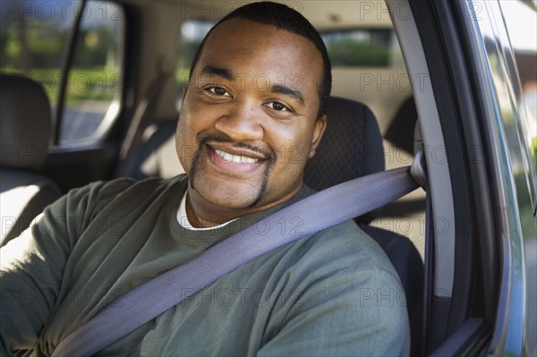 African man driving car