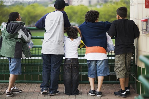 Boys leaning against railing