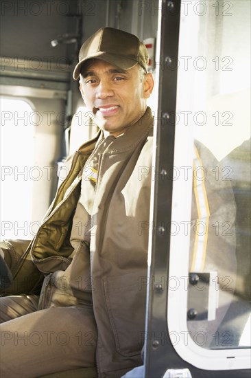Hispanic delivery man sitting in truck