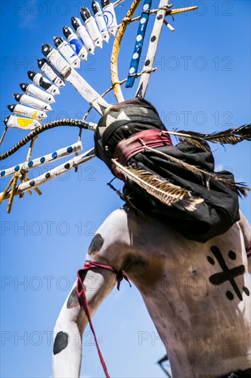 Apache man dancing in traditional regalia