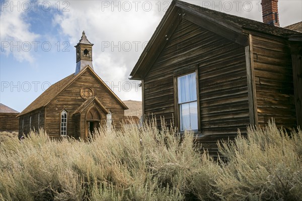 Rustic wooden buildings in tall grass