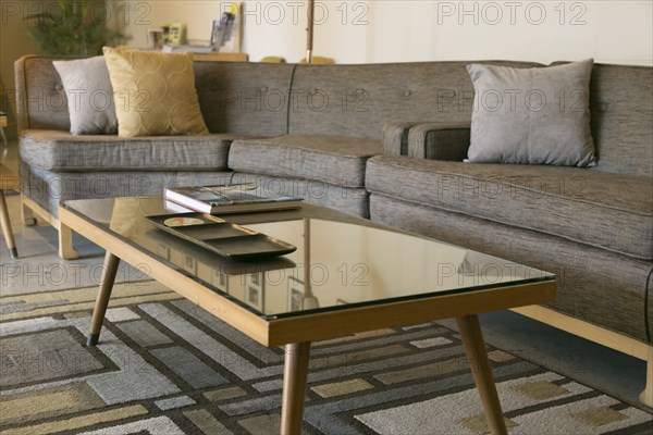 Coffee table with glass and sectional sofa