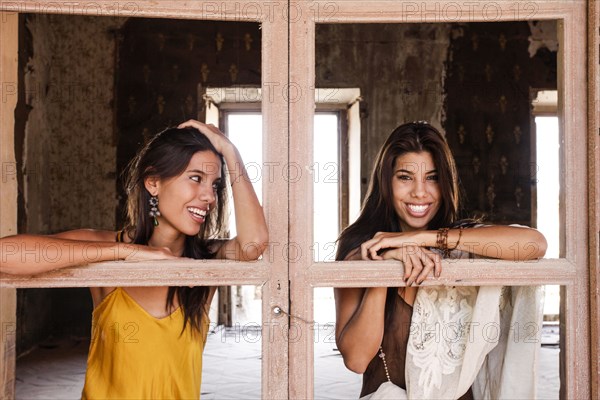 Brunette women leaning on windowless doors