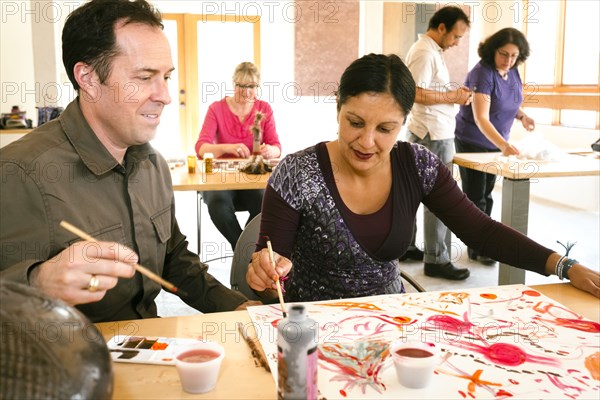 People painting in art class