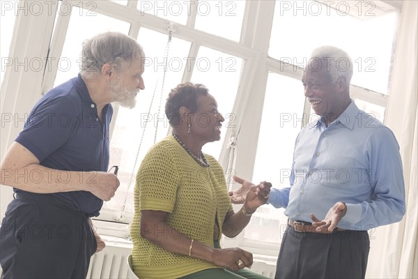 Older people laughing near window