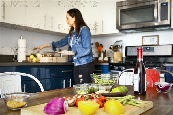 Woman chopping vegetables in kitchen