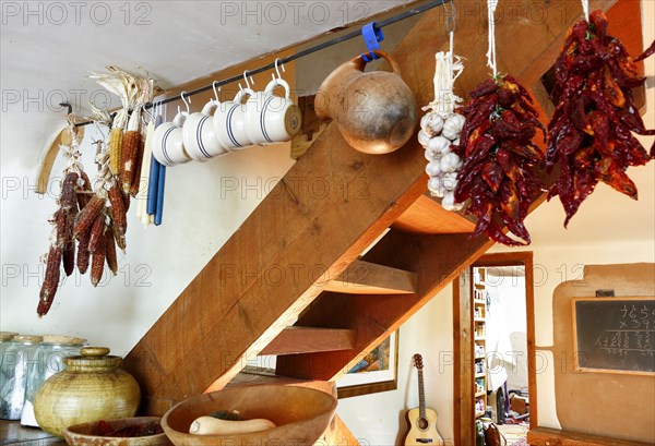 Cups and dried food hanging in traditional indigenous kitchen