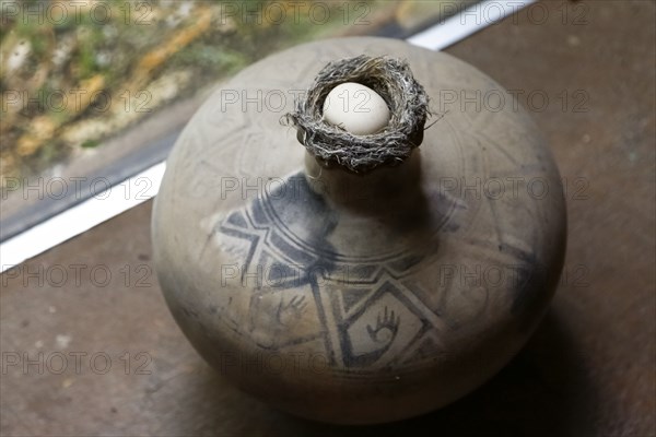 Egg in nest on vase