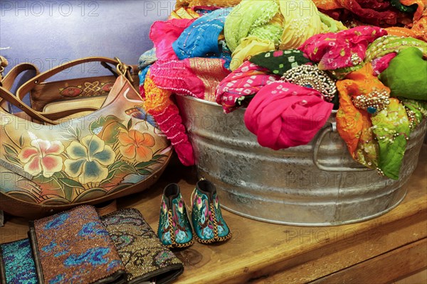 Metal basket of fabric on table in store