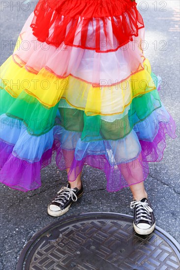 Person wearing rainbow skirt