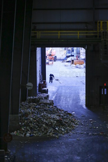 Man sweeping garbage with broom