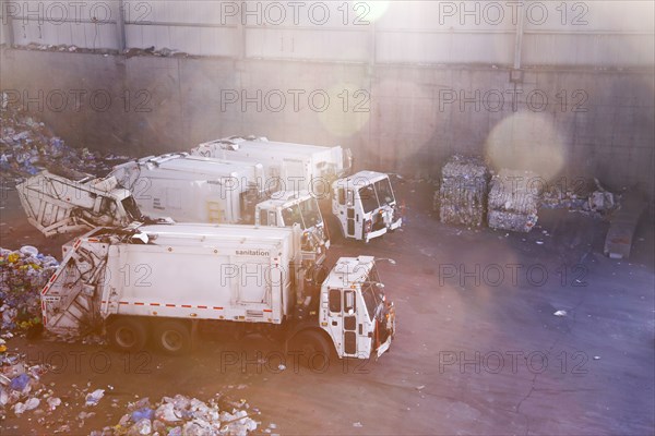 Garbage trucks unloading trash