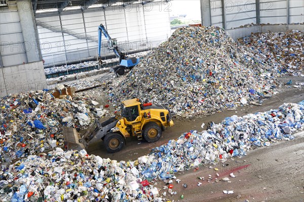 Bulldozer pushing pile of trash